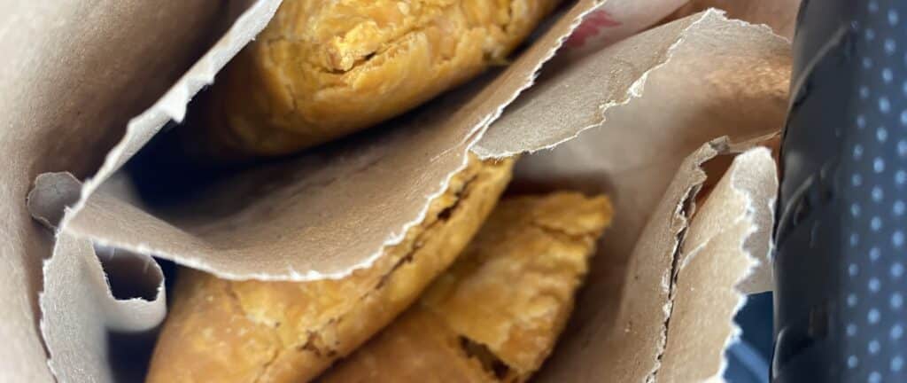 Jamaican patty and cocoa bread served as a Jamaican breakfast on the go