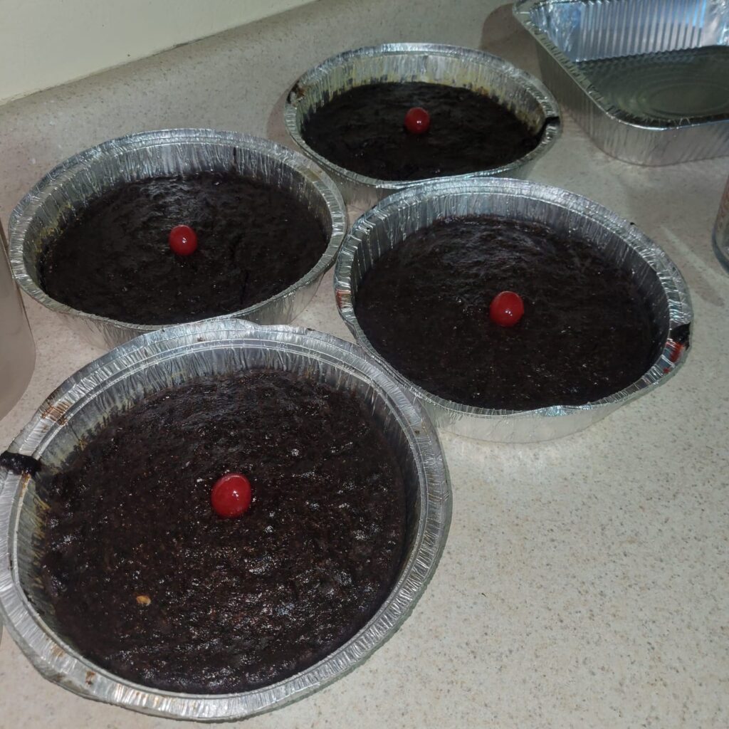Jamaican Christmas fruit cakes baked in foil pans with cherries on top