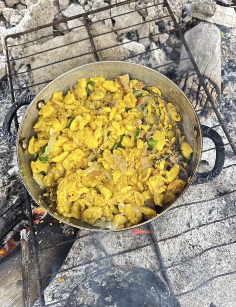 ackee cooking with seasoning in Jamaican dutch pot