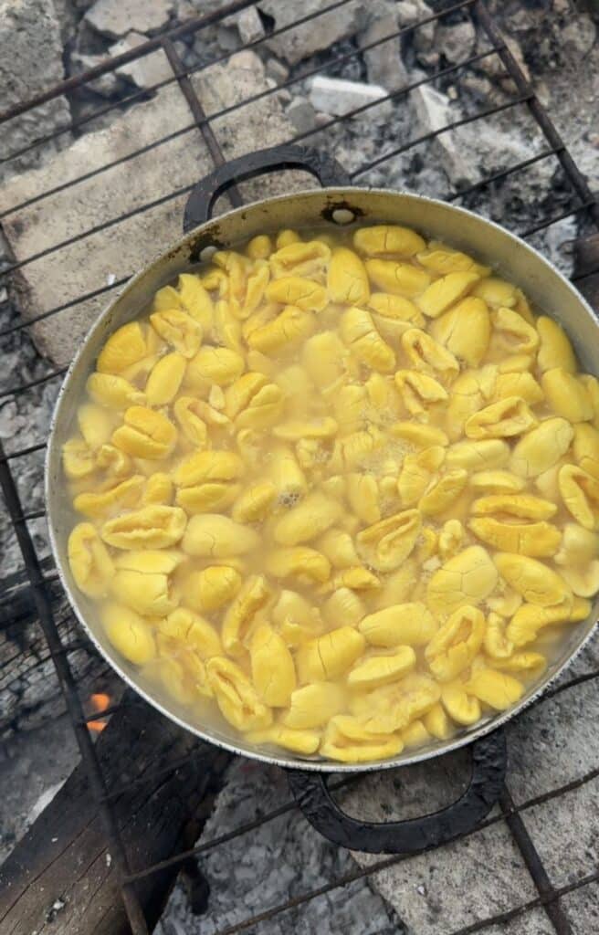 ackee boiling in pot over outdoor fire Jamaica