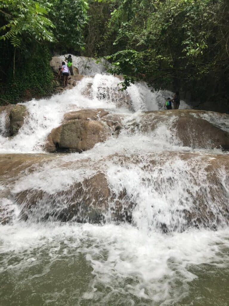 Visitors climbing the cascading terraces of Dunn’s River Falls in Jamaica.