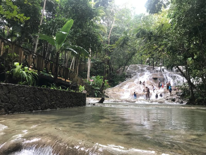 Water-level view looking up at Dunn’s River Falls in Jamaica.
