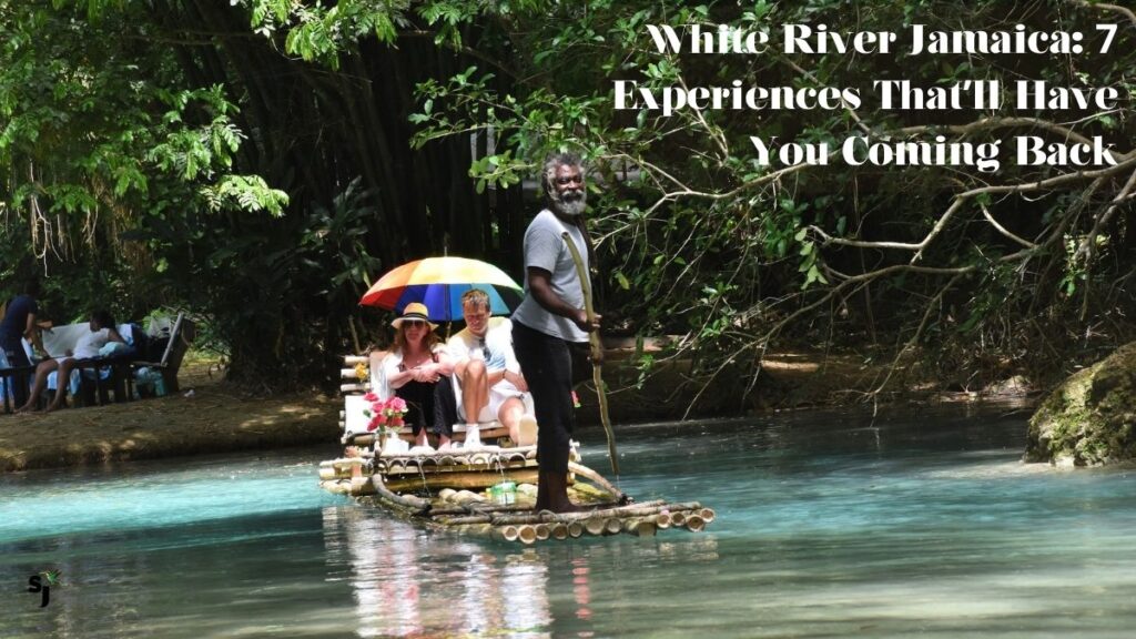 Bamboo raft captain guides tourists down White River Jamaica through lush tropical jungle