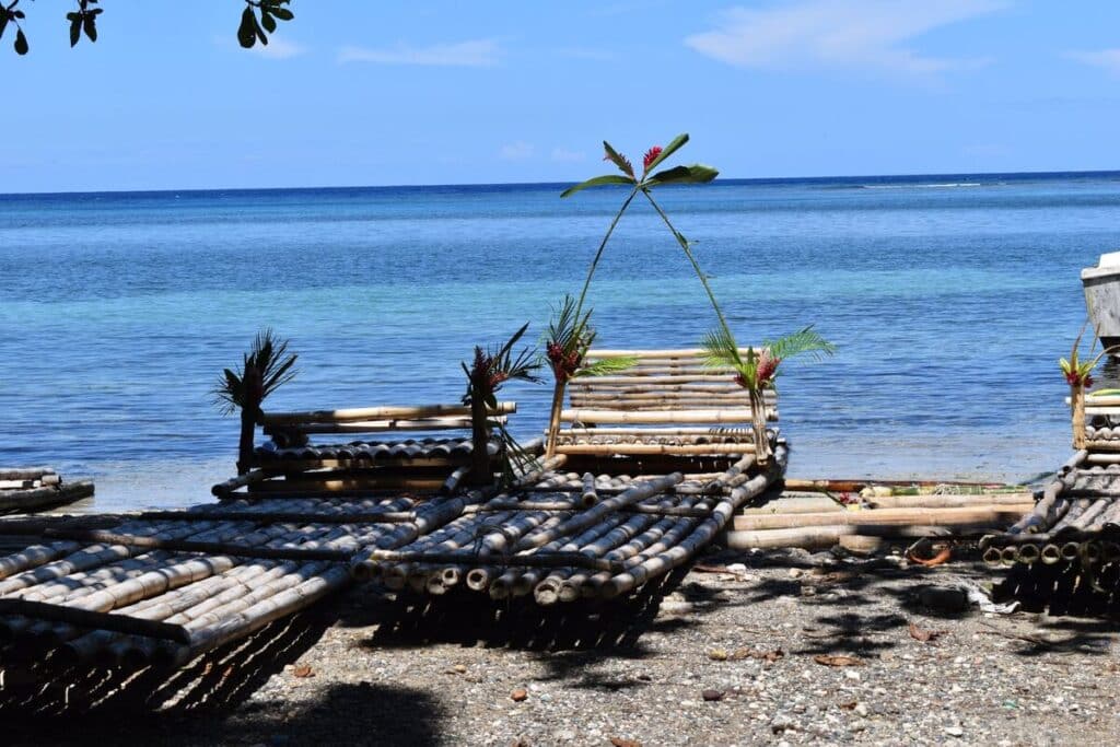 Decorated bamboo rafts resting on the shore of the Blue Lagoon, Portland Jamaica