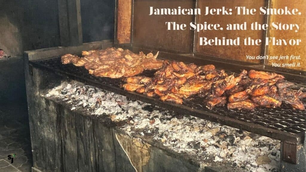 Jamaican jerk chicken slow cooking over charcoal with pimento wood smoke