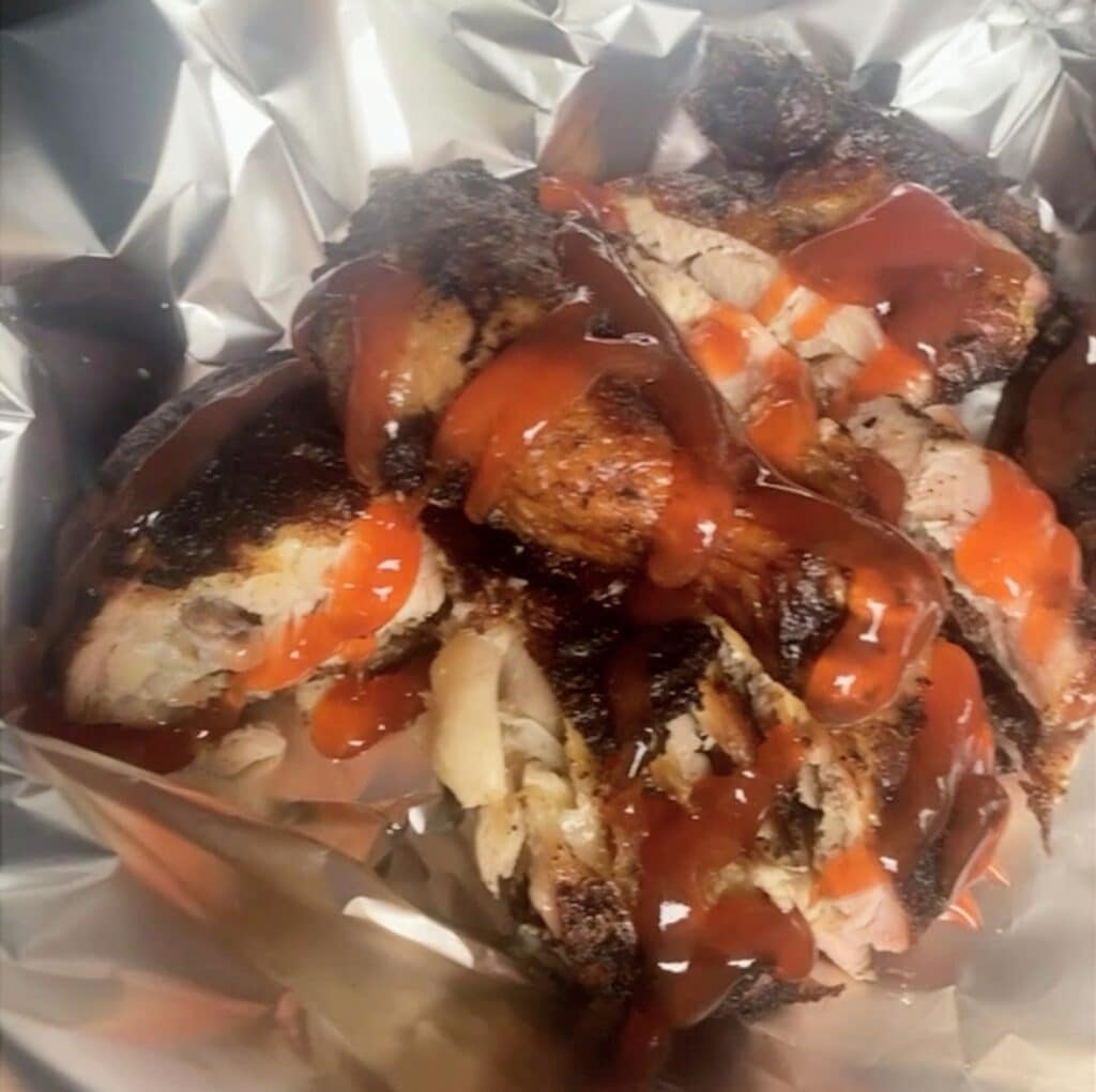 Jamaican jerk chicken wrapped in foil with ketchup roadside style