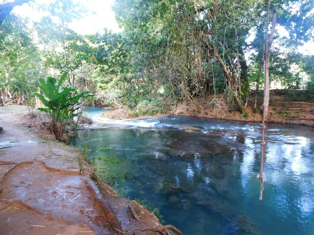 Natural swimming pool with rope swing at Calby's Hidden Beauty, White River Jamaica