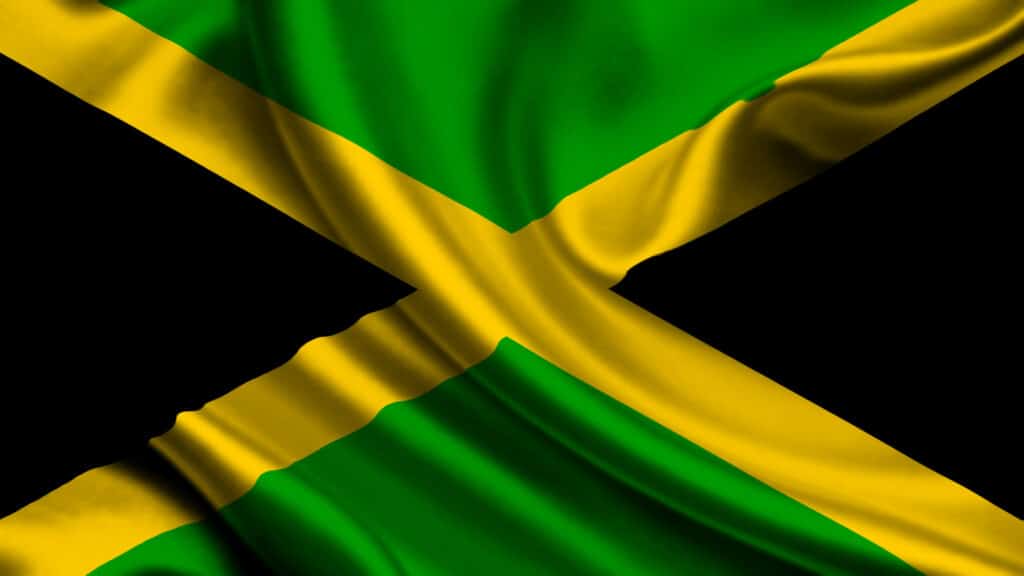 Jamaica national flag, one of the official Jamaica national symbols, featuring the black, green, and gold cross design adopted in 1962.
